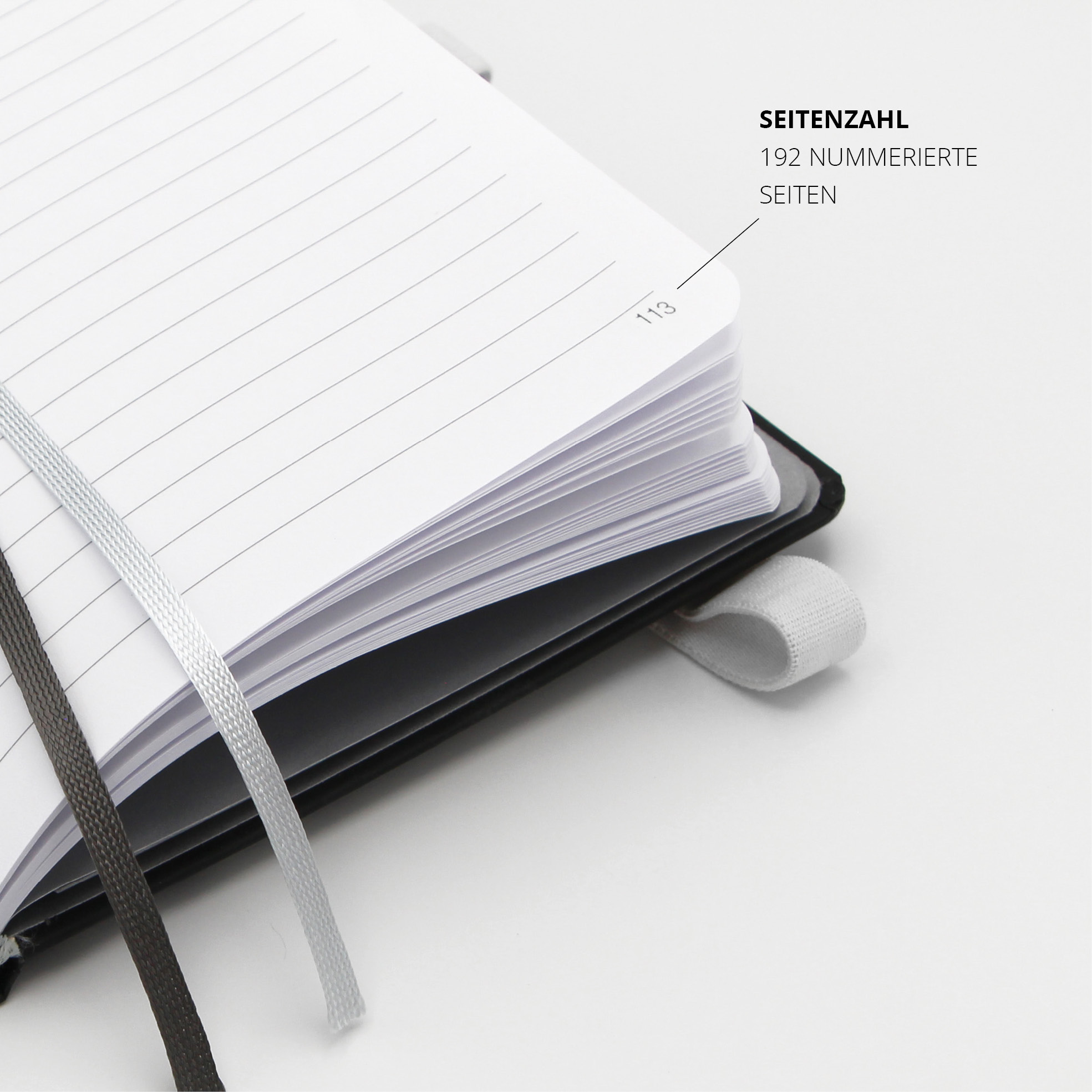 Linierte Seiten mit Seitenzahl 113, 192 nummerierte Seiten, weiße Stiftschlaufe sichtbar.