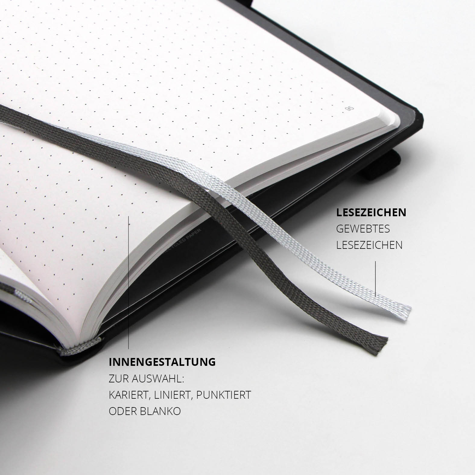 Zwei gewebte Lesezeichen in Grau und Schwarz zur einfachen Orientierung im Notizbuch.