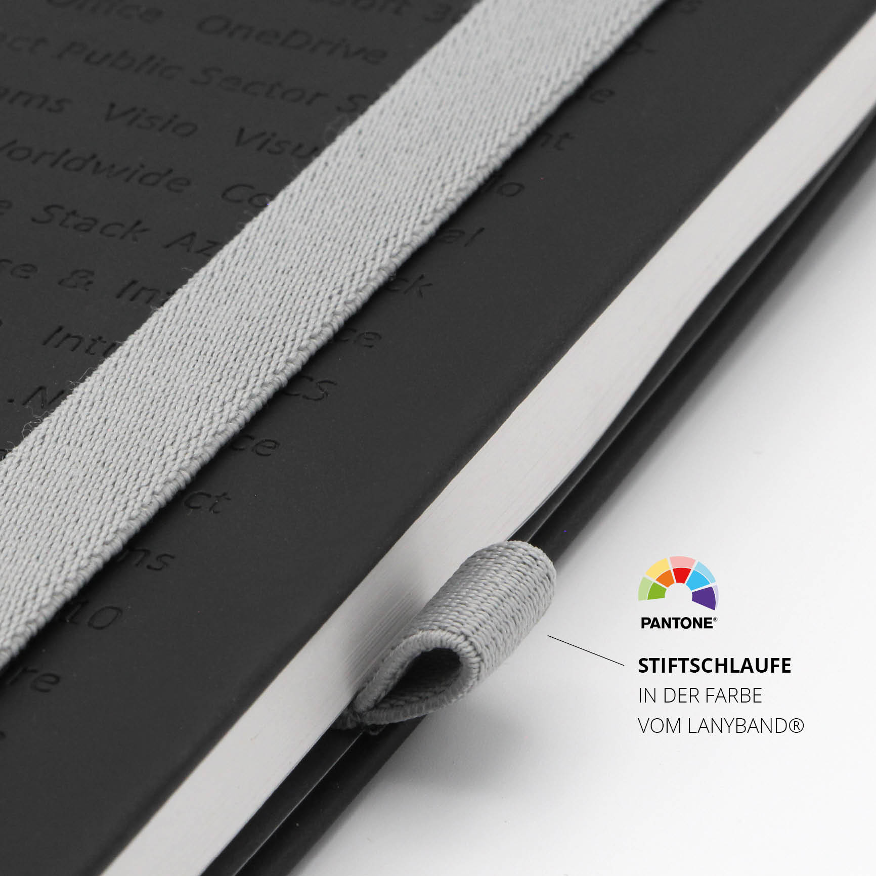 Detailaufnahme der Stiftschlaufe am Microsoft Notizbuch. Farbe passend zum Lanyband®, ideal für personalisierte Notizbücher.