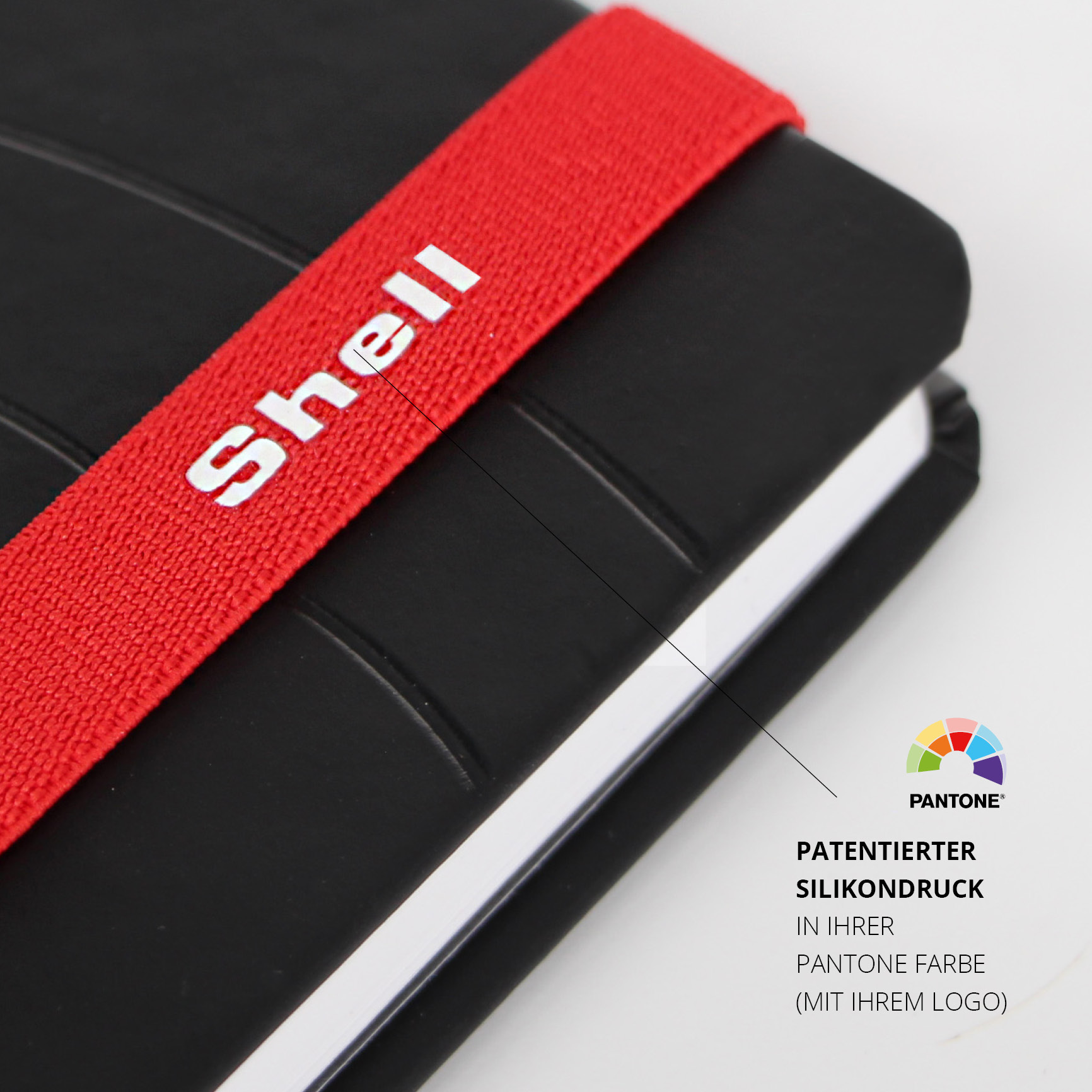 Silikondruck auf LanyBand® mit Shell-Logo in Pantone-Farbe für das individuelle Notizbuch.