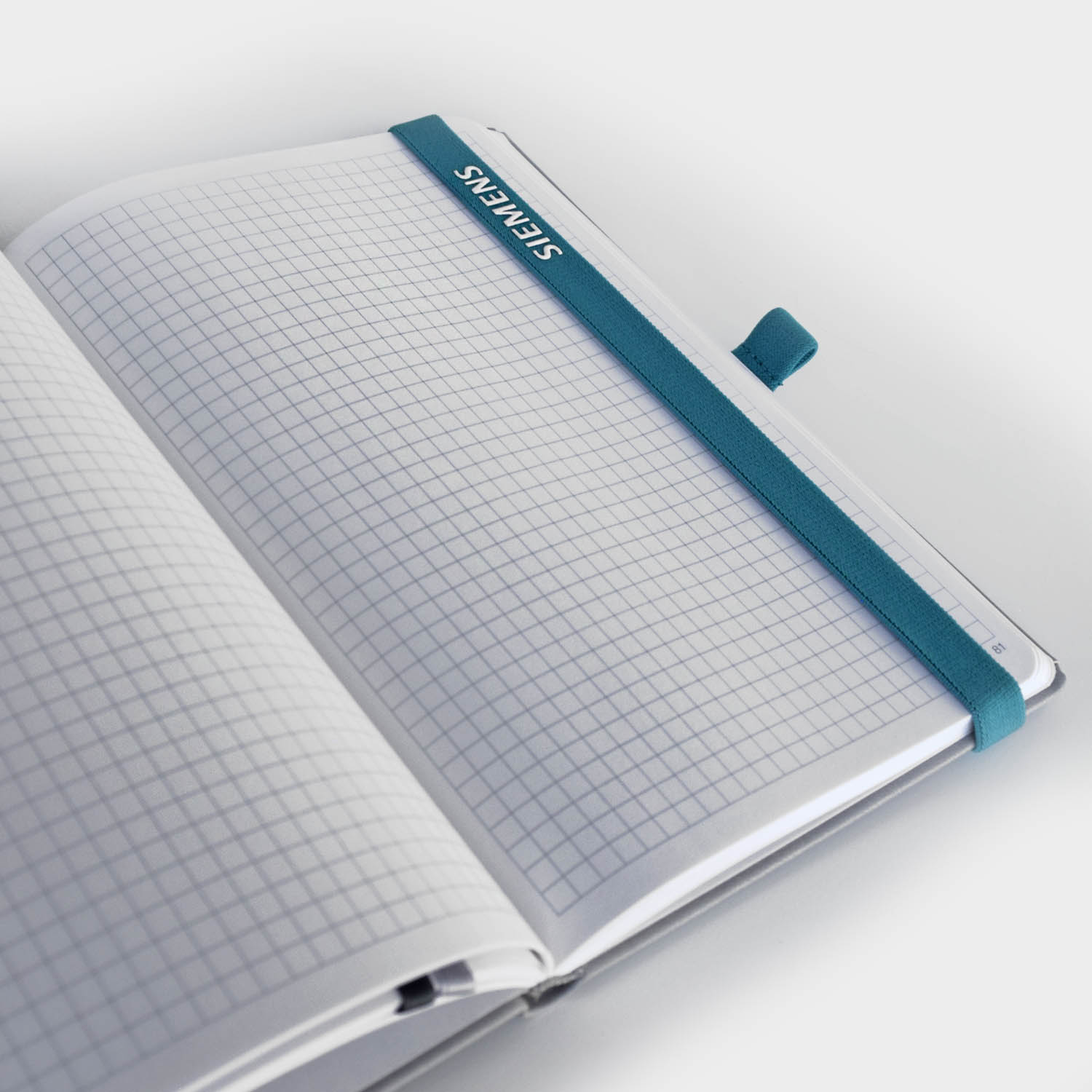 Siemens-Notizbuch mit karierten Seiten und elastischem Band – Hochwertiges, individuell gestaltbares Notizbuch mit nachhaltigem Design.