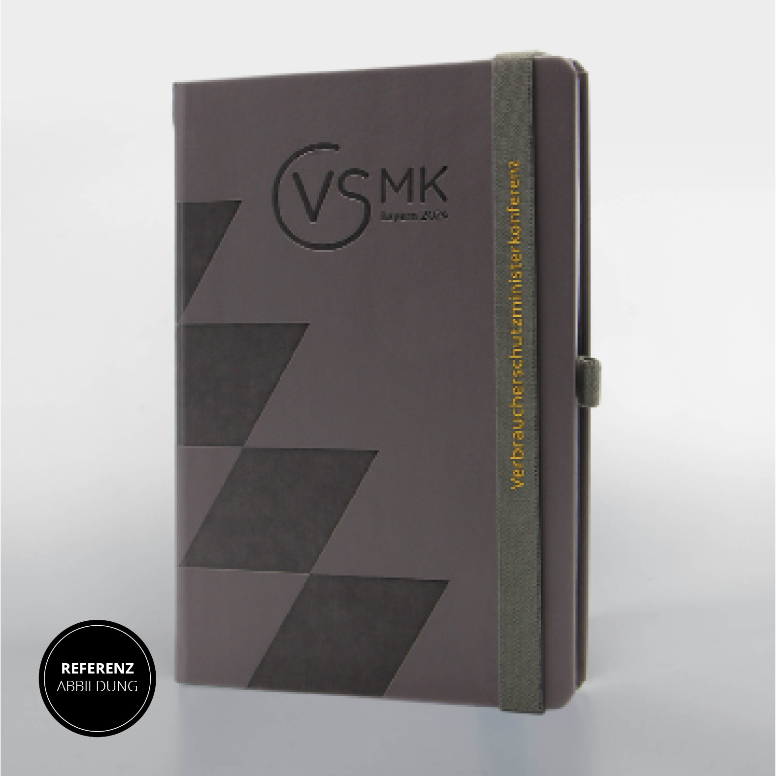 Vorderseite des Lanybook® Nature mit veganem Apfelleder, Silikondruck auf dem grauen Lanyband® und Logoprägung der VSMK Bayern 2024.