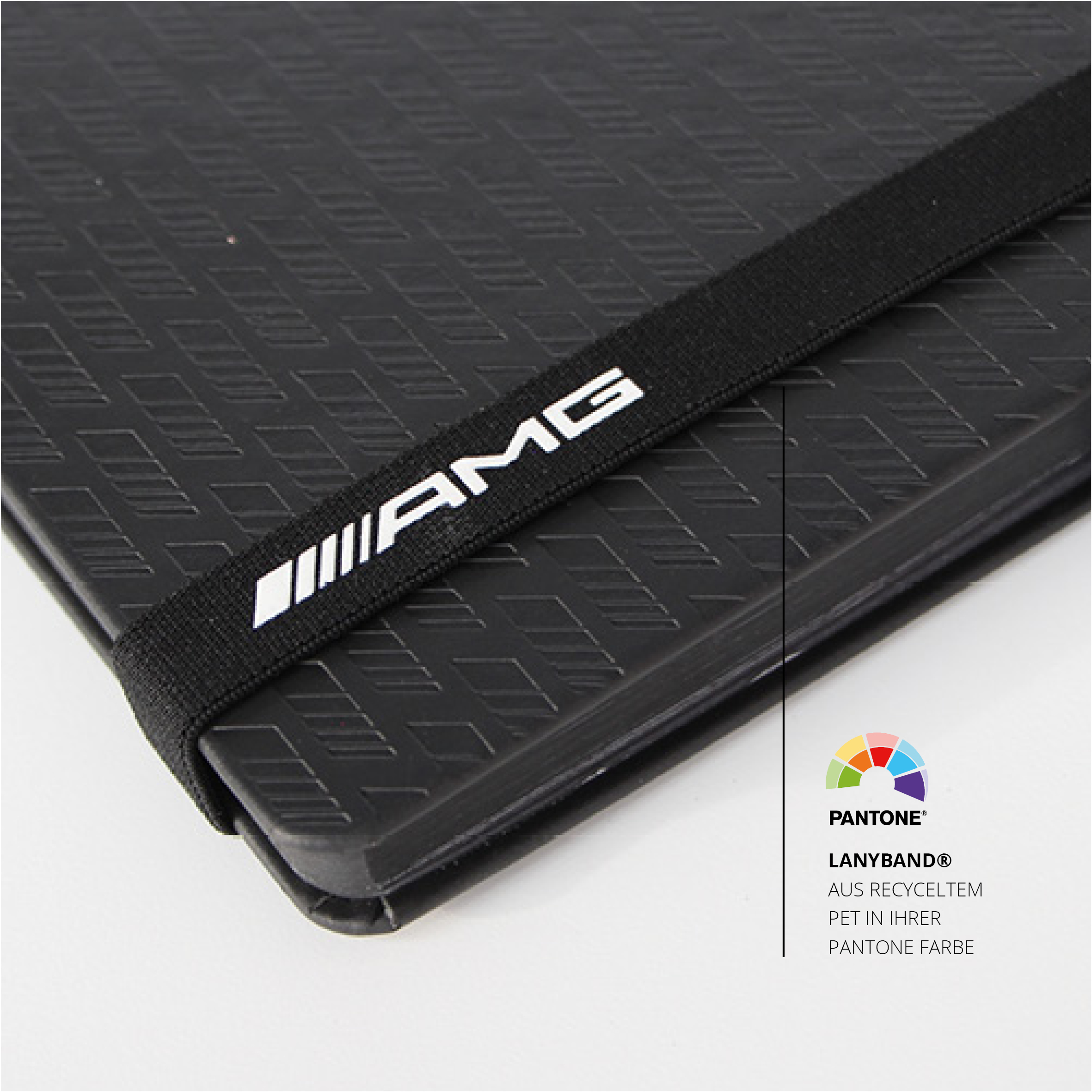 AMG personalisiertes Notizbuch mit patentiertem Silikondruck auf dem LanyBand®. Hochwertiges Detail für stilvolles Corporate Branding und Firmengeschenke.