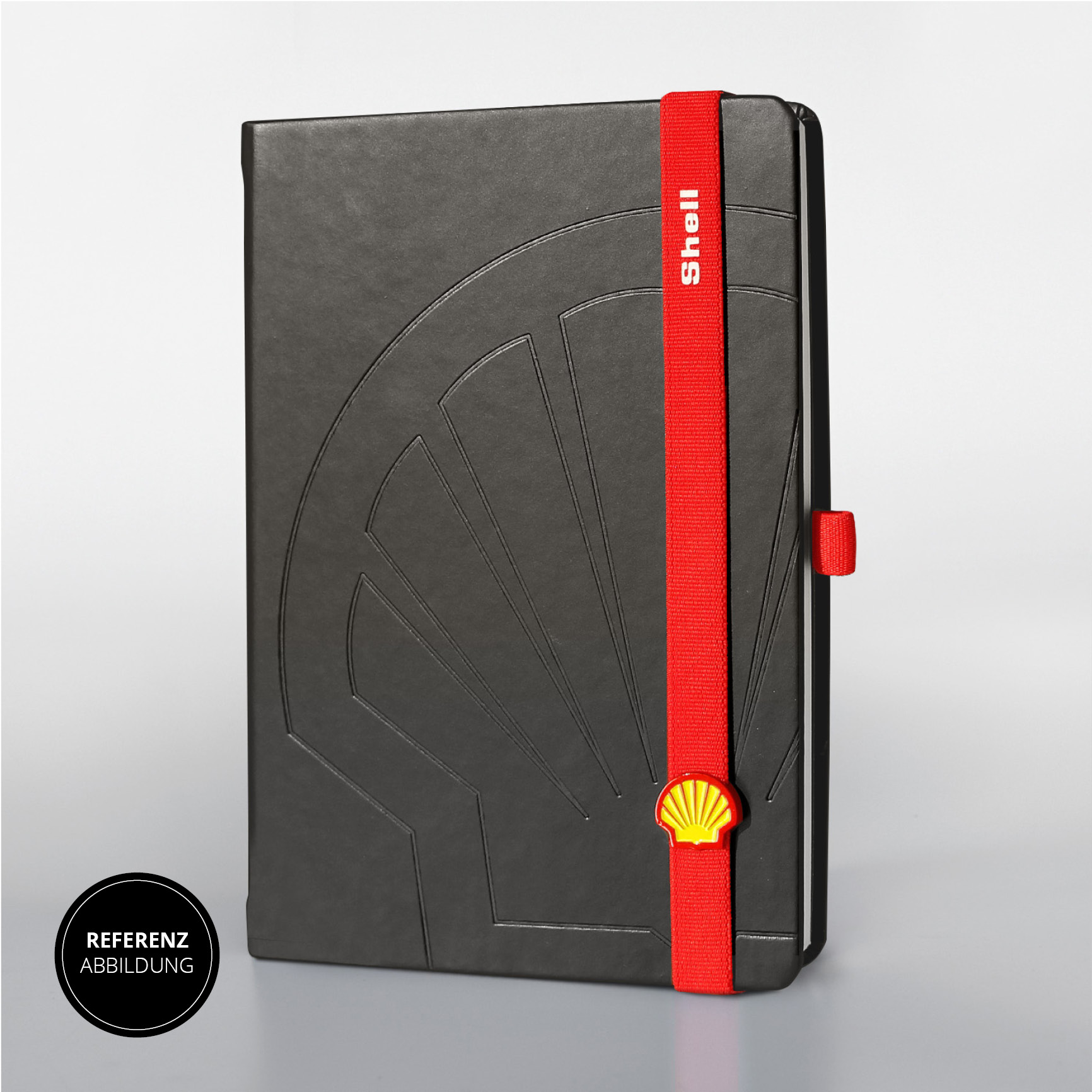Shell Notizbuch mit geprägtem Logo und rotem Verschlussband mit Shell-Symbol.