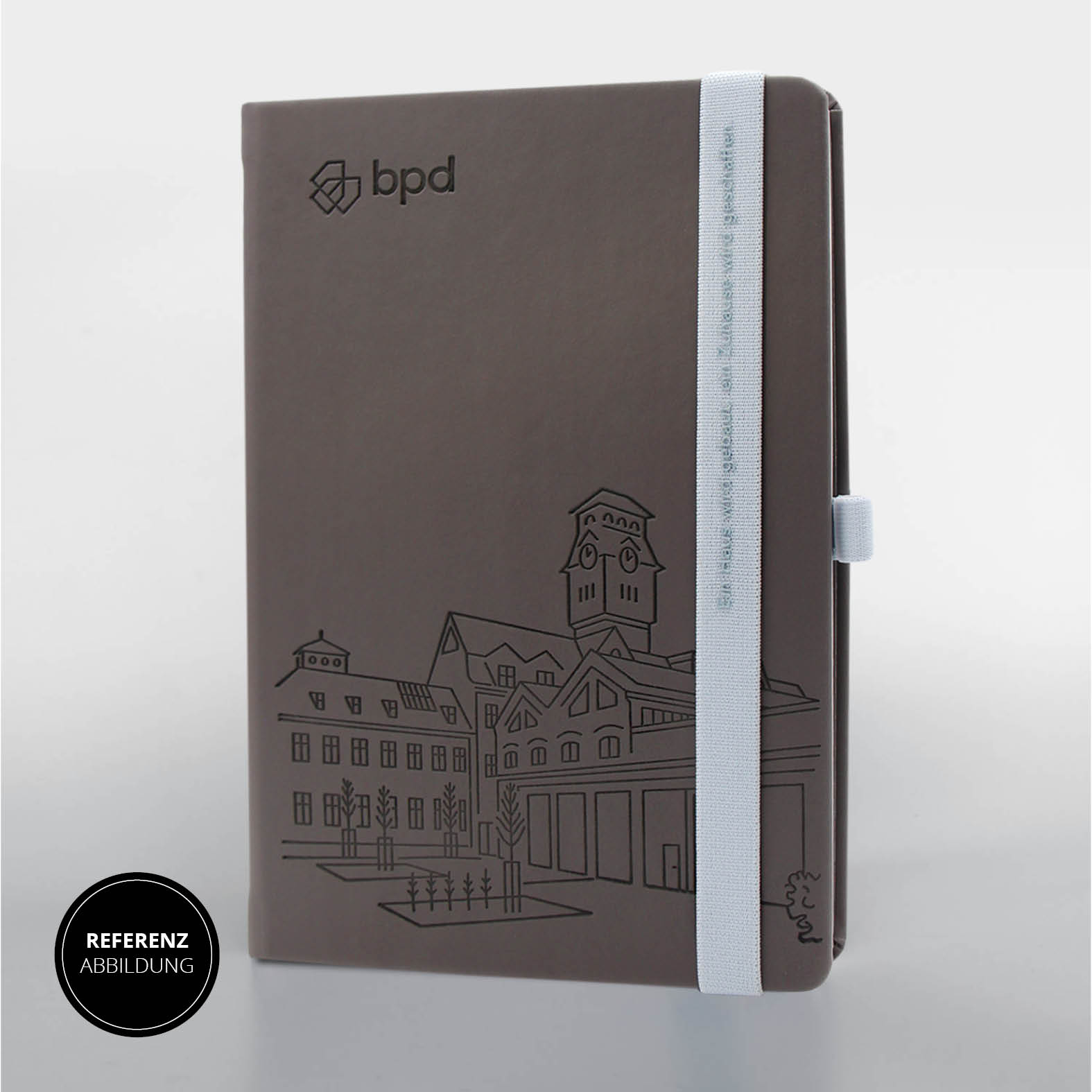 Graues Lanybook® Nature A5 mit individueller Prägung, hellblauem Lanyband® und bpd Logo auf dem Einband.
